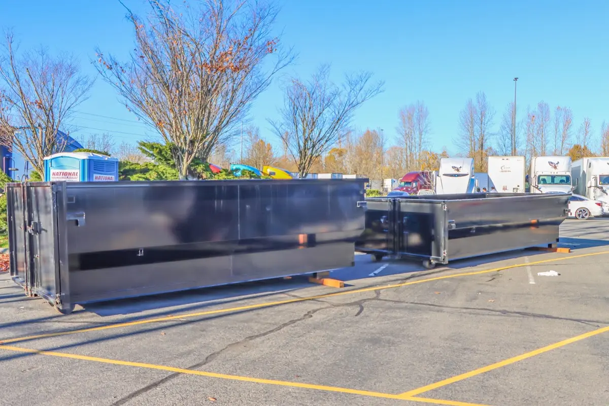 Professional dumpster rental service with roll-off container on residential driveway in Thurmont